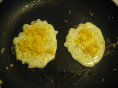 These are as close to circles as I ever got. Once one side is half cooked, you throw on a bunch of that cheddar cheese and then flip 'em over in another minute or so